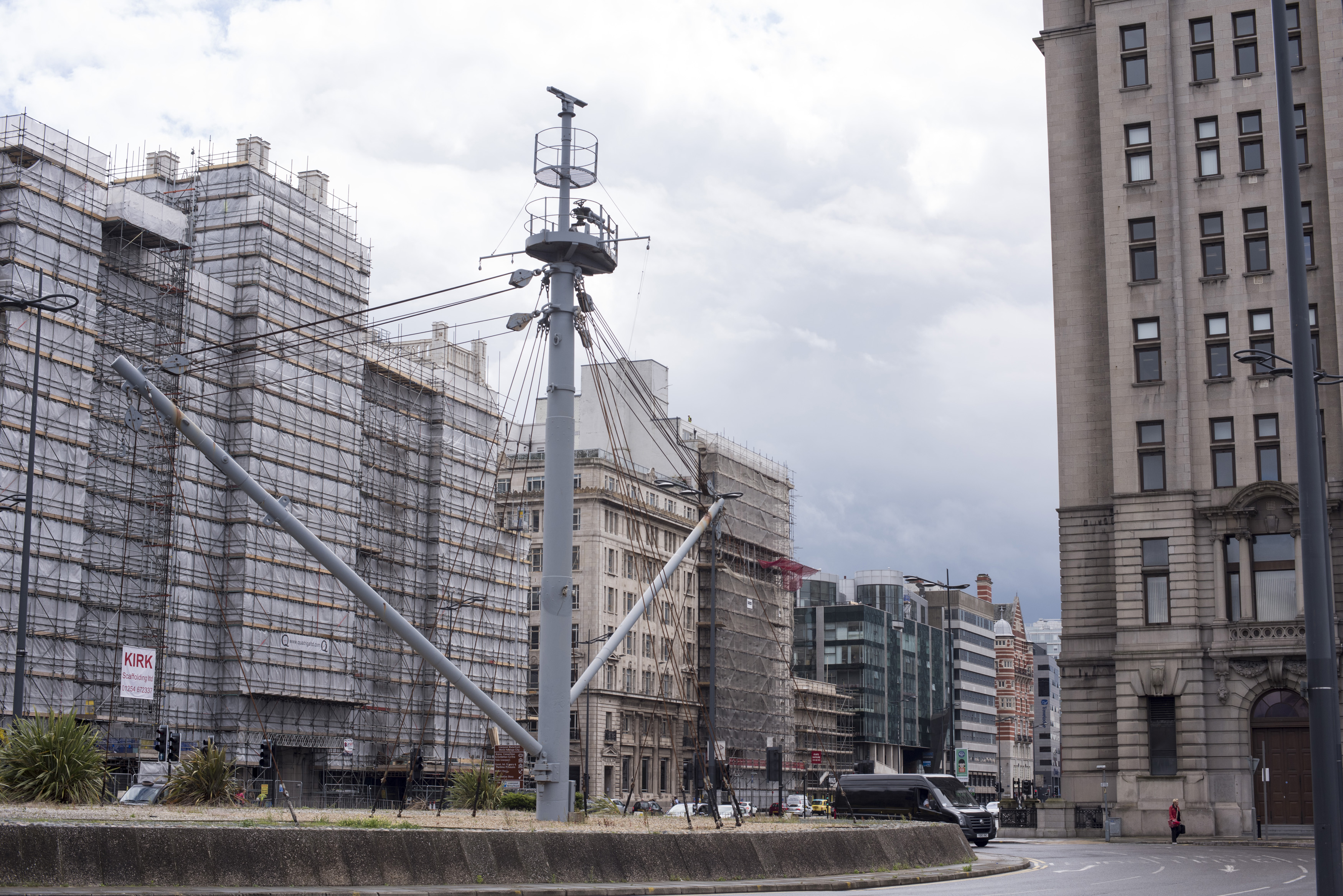 an image of Large ship mast structure surrounded by buildings in Liverpool, United Kingdom
