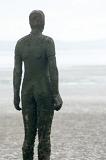 Close up on rear of Another Place statue by Antony Gormley in Crosby, United Kingdom