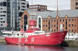 Large red light boat BAR moored at dock in Liverpool waterfront. A popular destination for tourists in the United Kingdom.
