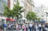 Crowds of various adults and children walking and mingling in Liverpool central shopping district