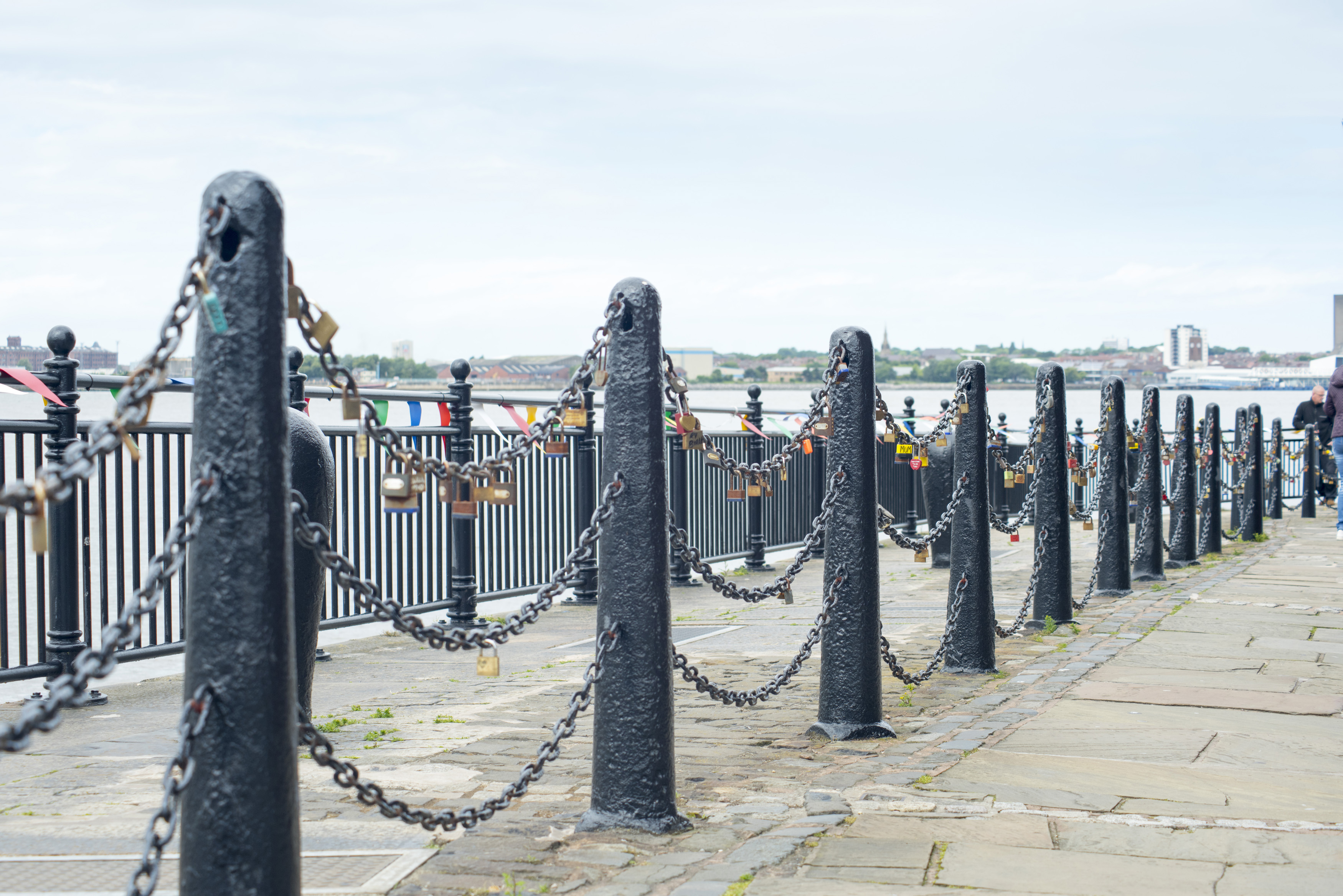 an image of Various padlocks on iron chains at waterfront at Liverpool Mersey waterfront in the United Kingdom