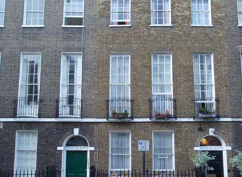 Georgian terraced houses with their tall elegant sash windows and arched entrances in London, UK
