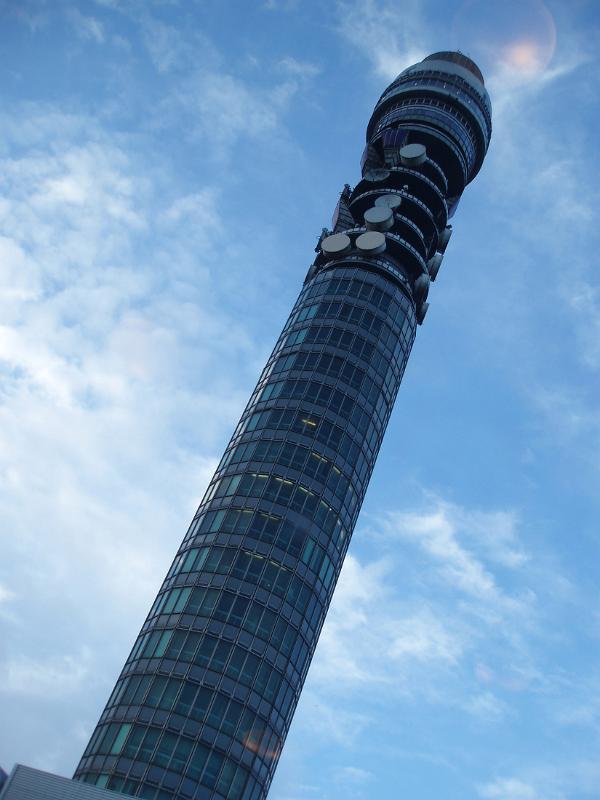 BT Tower, London, the 189 metre high post office telecommunications tower and a well known landmark in the city viewed from below looking up against a blue sky