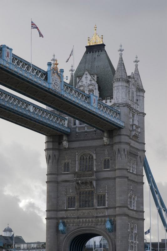 close up on one of the towers on london tower bridge showing the victorian gothic architectural style of the stone cladding