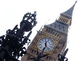 Tilted angle view of ornate wrought iron work and the clock face of Big Ben, the clock tower for the old palace of Westminster, now an iconic landmark and tourist attraction