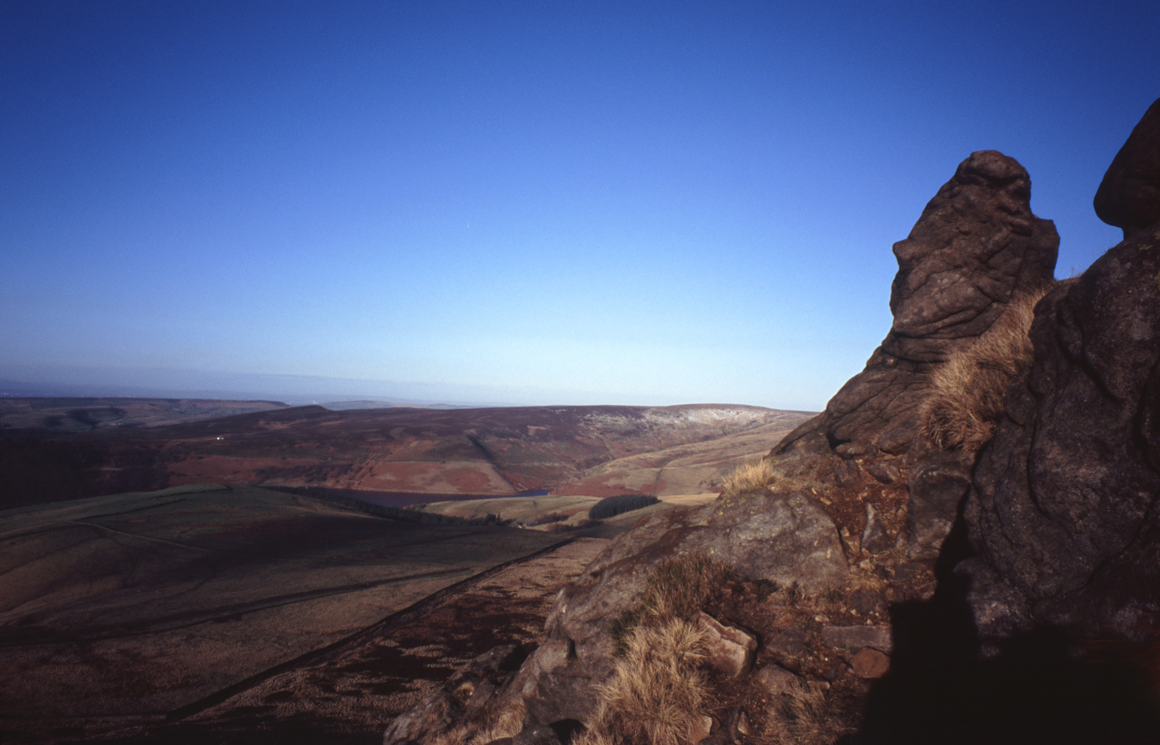 an image of Panorama of Kinder Scout, a moorland plateau and National Nature Reserve n the Dark Peak of the Derbyshire Peak District in England. Captured with Gradient Blue Sky Background.