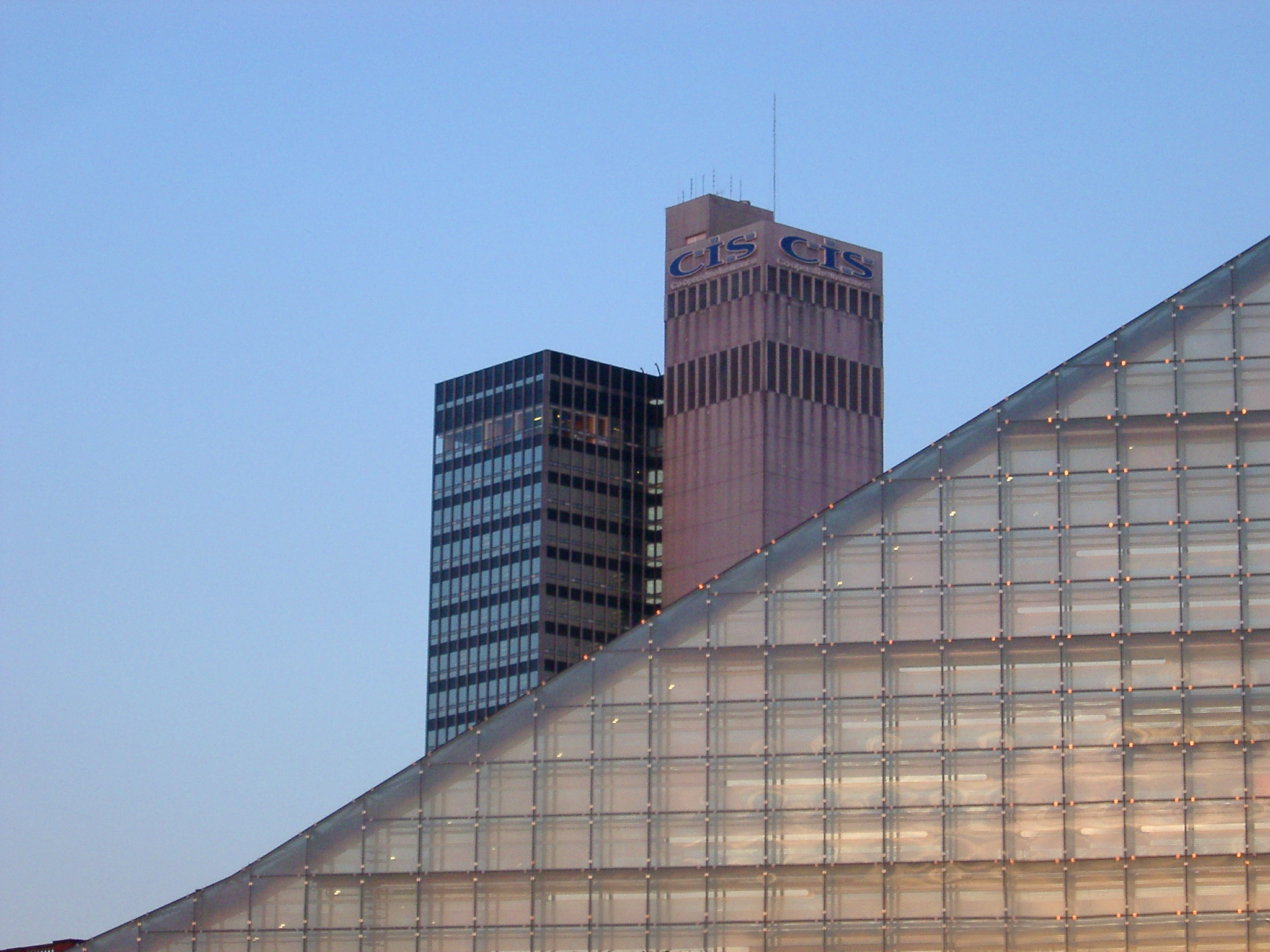 an image of Modern Architectural style of the urbis Building and Cis Tower at Manchester, England. Captured with Light Blue Sky Background.