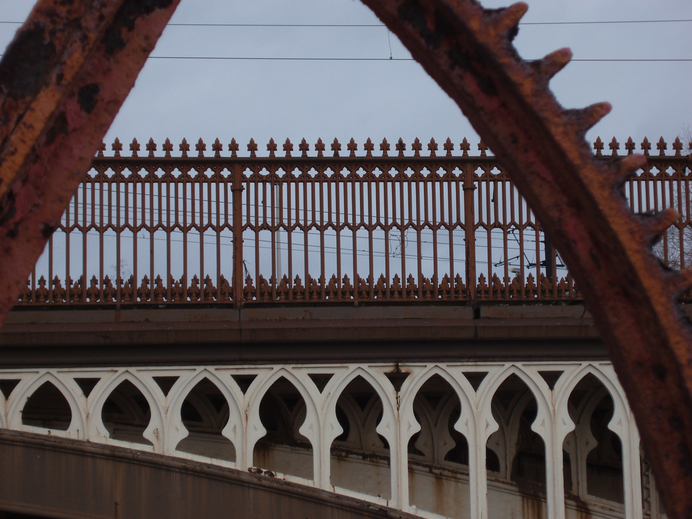 an image of details of an industrial era gear wheel and railway viaduct in manchester castlefields