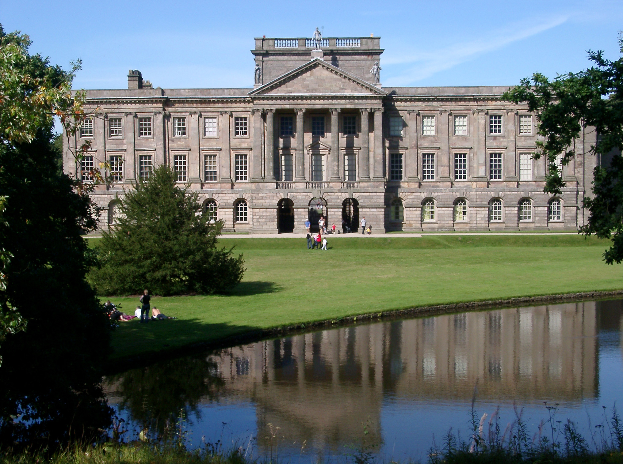 an image of Lyme Park, a large country mansion south of Disley in Cheshire, reflected in a tranquil pond