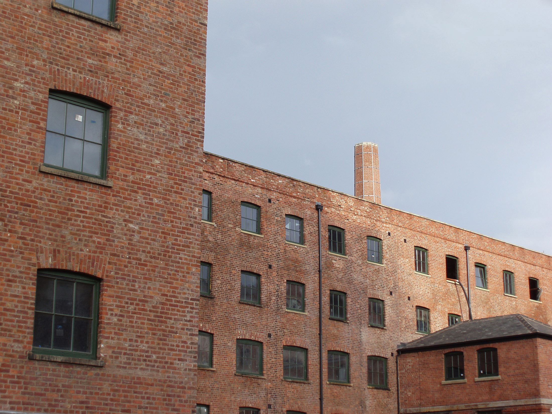 an image of industrial eara in central manchester brick frontage of warehouse buildings