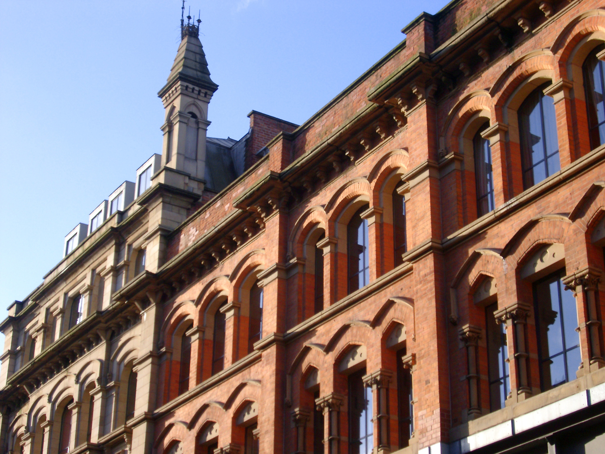 an image of Vintage Style of Building with Glass Windows at Oldham Street, Manchester