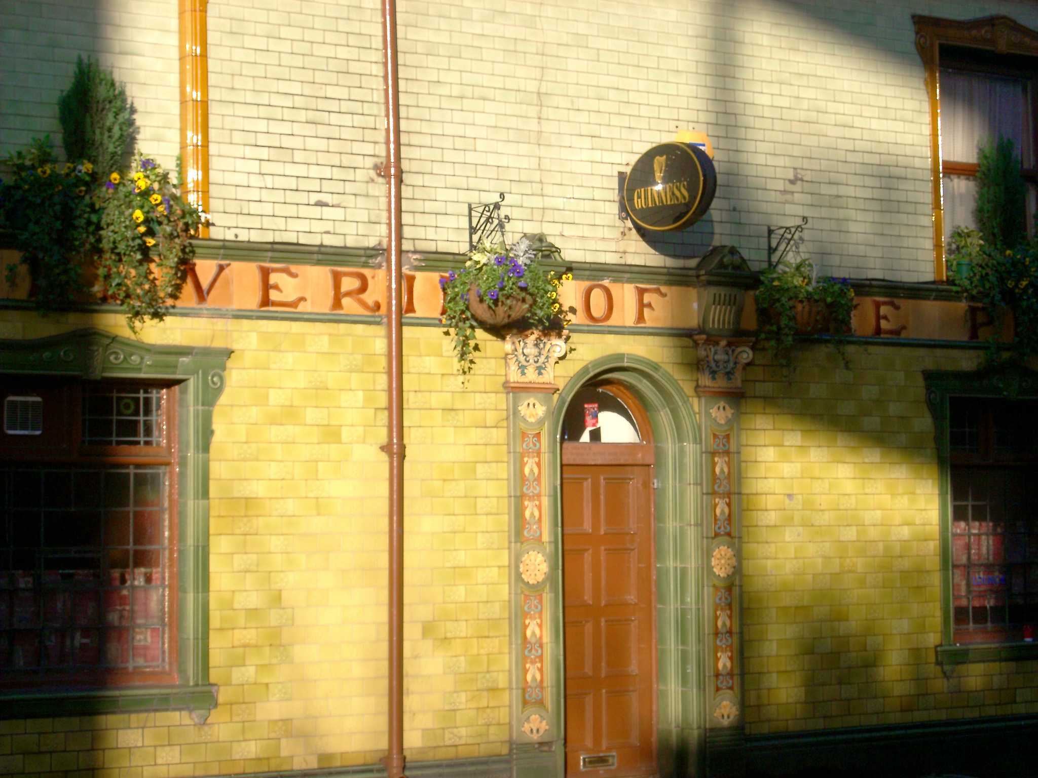 an image of architectural details tiled facade of the peveril of the peak public house