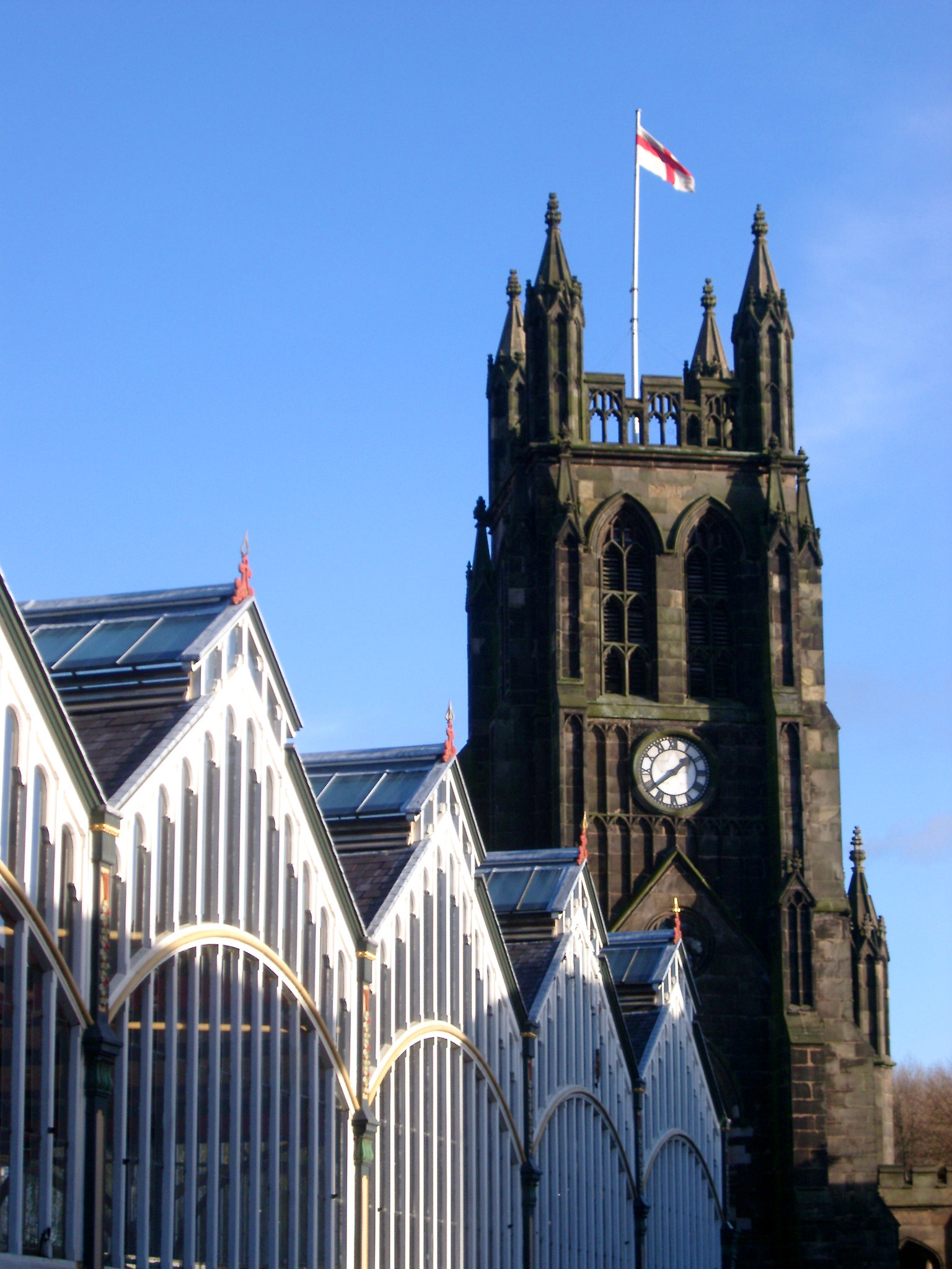 an image of Historic Tower of St. Mary's Church in Stockport, England. Captured with Light Blue Sky Background.