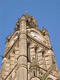 View looking up at the ornate stone Gothic revival architecture of the Manchester Town Hall clock tower