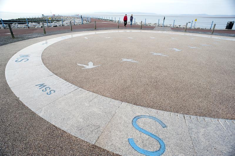 a giant compass set into the pavement breaks up what would otherwise be a quite drab walk along the stone pier
