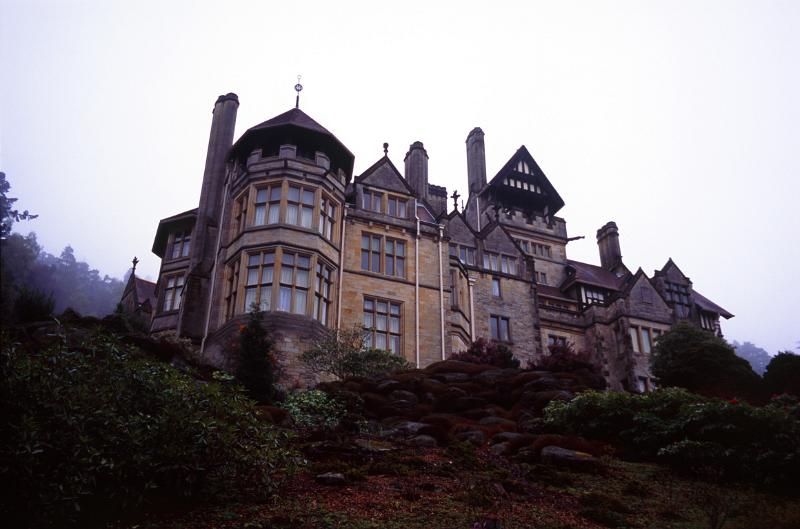 View on the skyline of the large stone facade of Cragside stately home, the first house to have electricity