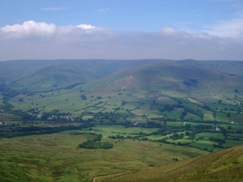 View from Mam Torr to Kinder Scout at Edale with a lush green scenic panorama across rolling hills to the plateau, Derbyshire, UK
