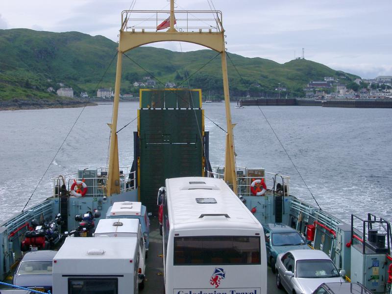 View over the roofs of the cars and bus parked on the deck of the Maillag to Skye ferry as it crosses the straits