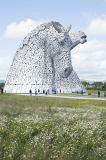 Kelpies horse monuments surrounded by scattered clouds in grassy field at Falkirk, Scotland