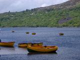 Wooden rowboats moored on the lake at Llanberis, Gwynedd, North Wales on a cloudy day