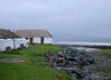 Rustic thatched white house with rough plastered walls in the Hebridies Western Isles used as a hostel