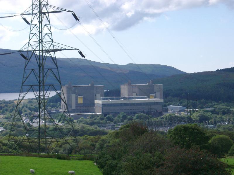 Nuclear Power Station in Trawsfynydd, Wales, showing an exterior view of the buildings and installation with an electric pylon and cables in the foreground