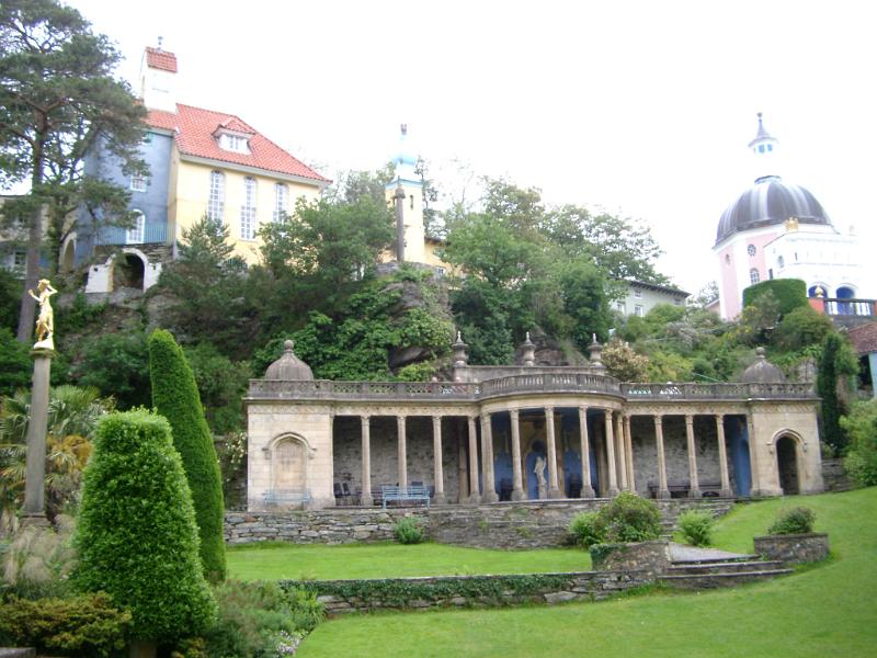 Portmeirion architecture, Wales, modeled on an Italian village , showing a building with a colonnade portico overlooking landscaped gardens in this popular tourist resort