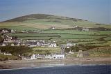 Picturesque view of Aberdaron on the Welsh coast of the Llyn peninsula set amongst lush green rolling hills