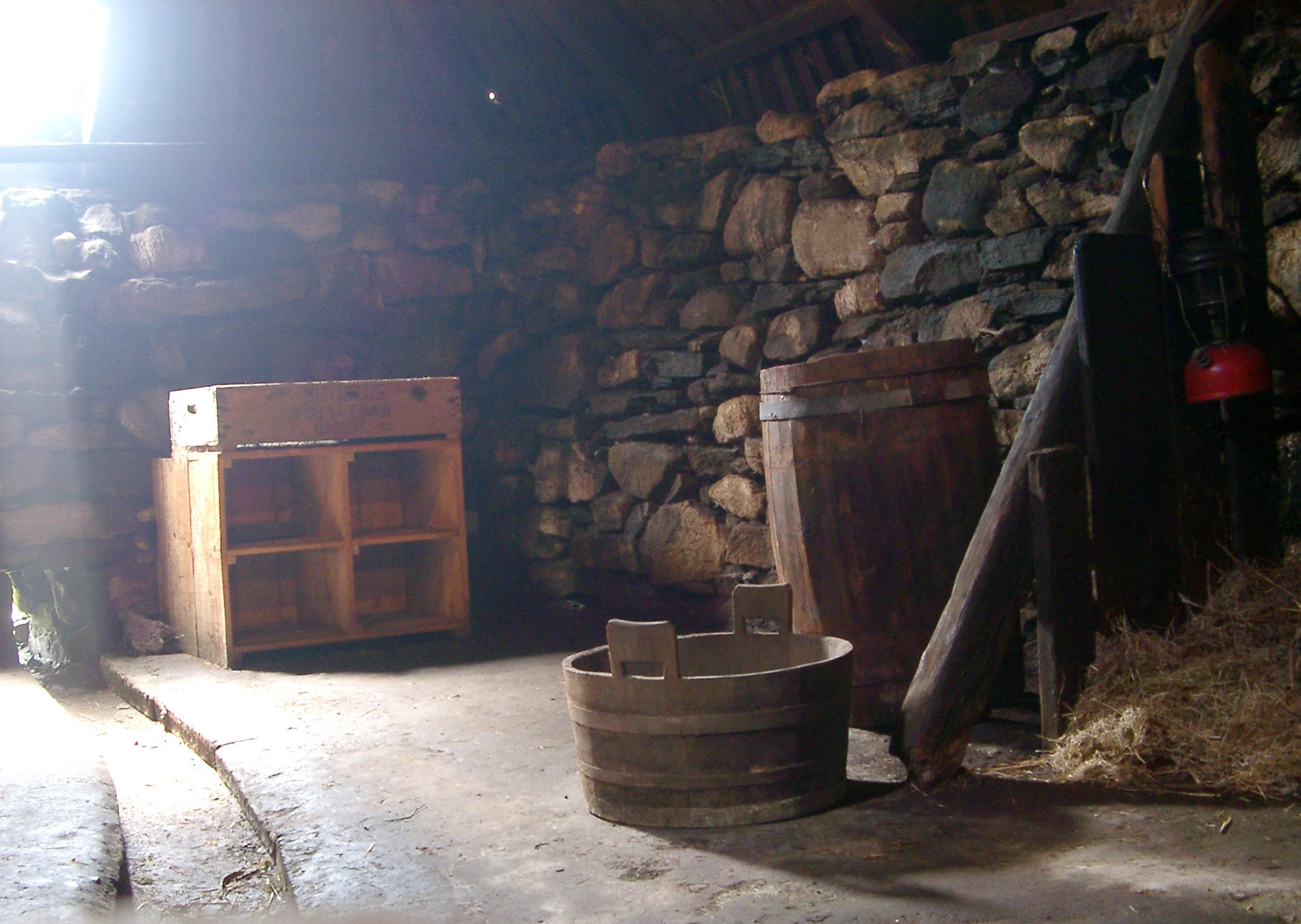 an image of Interior of Traditional Scottish Stone Blackhouse with Historic Artifacts