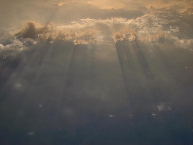 Suns rays shining through clouds Suns rays shining through a gap in the clouds in a background cloudscape image of nature and the environment