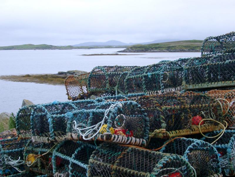 Crab pots stacked on the seashore Wire mesh crab pots stacked on the seashore of a loch in Scotland