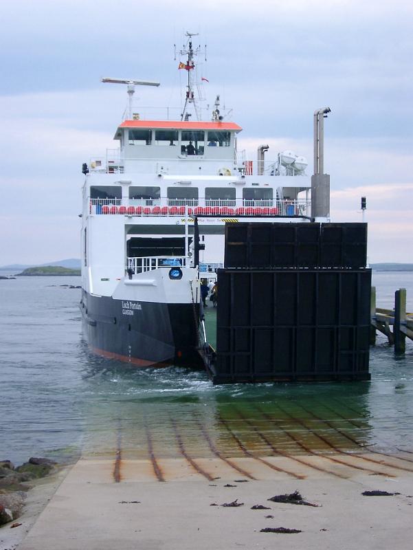 Large ferry at the Ramp Large black and white ferry Resting at the Sea Port, with clear sea water, in Scotland