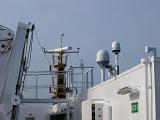Detail of nautical radar and navigation equipment for communication on a ferry against a clear blue sky
