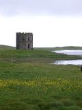 View of Scolpaig Tower on Loch Shoreline on Overcast Day, Outer Hebrides, Scotland