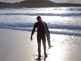 Silhouette of Surfer Carrying Surfboard near Shore, Lewis, Hebrides, Scotland