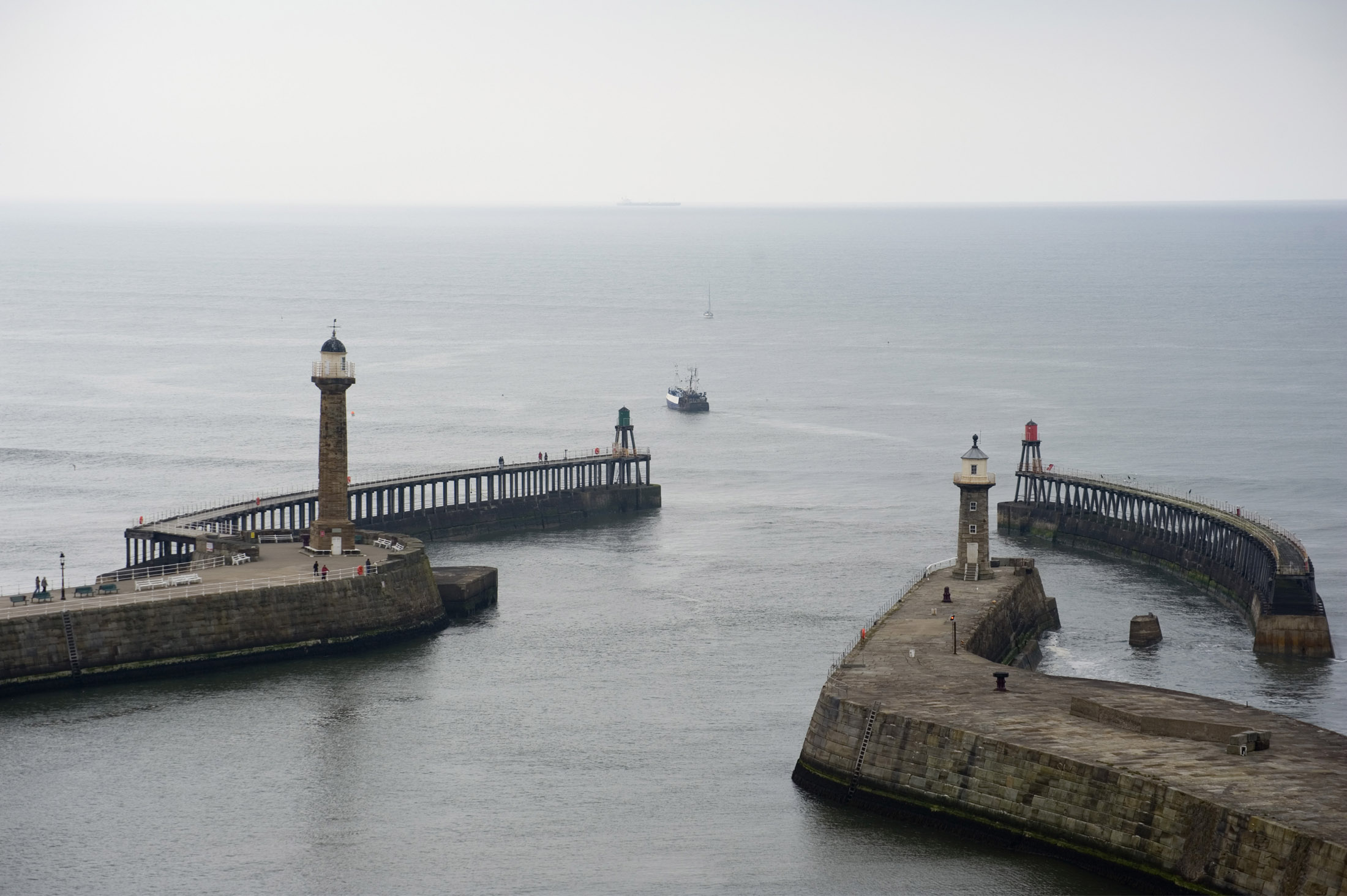 an image of two large harbour piers protect the lower harbour from the sea, on the ends are two breakwaters which further reduce the swell entering the bay