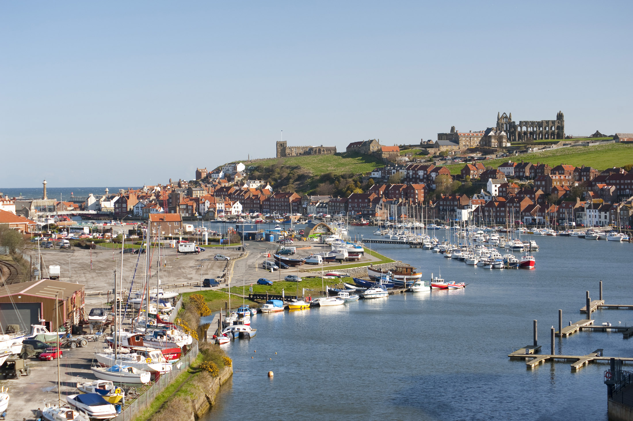 an image of the river esk flowing through the coastal town of whitby