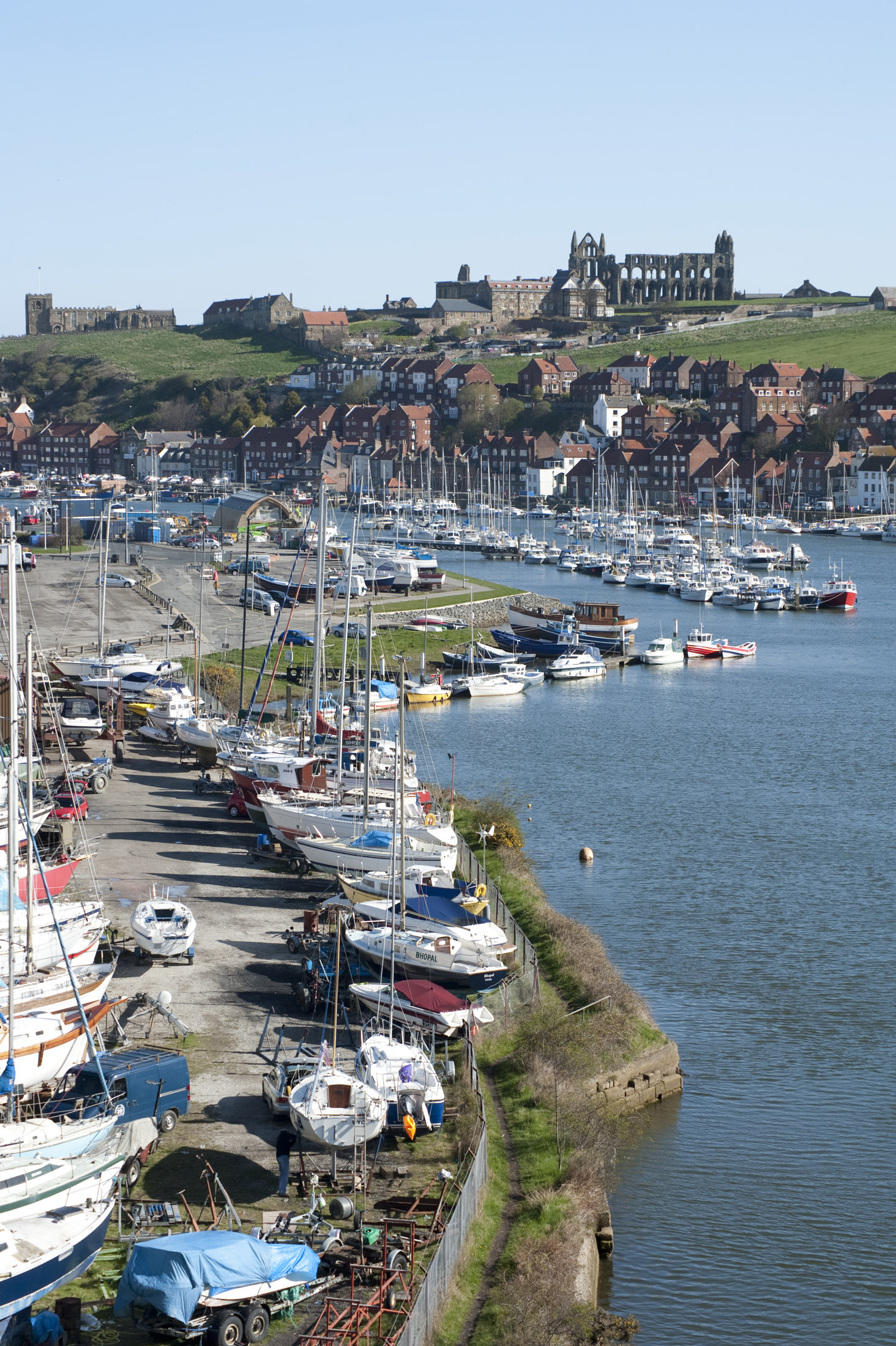 an image of boats moored on the banks of the river esk flowing through whitby
