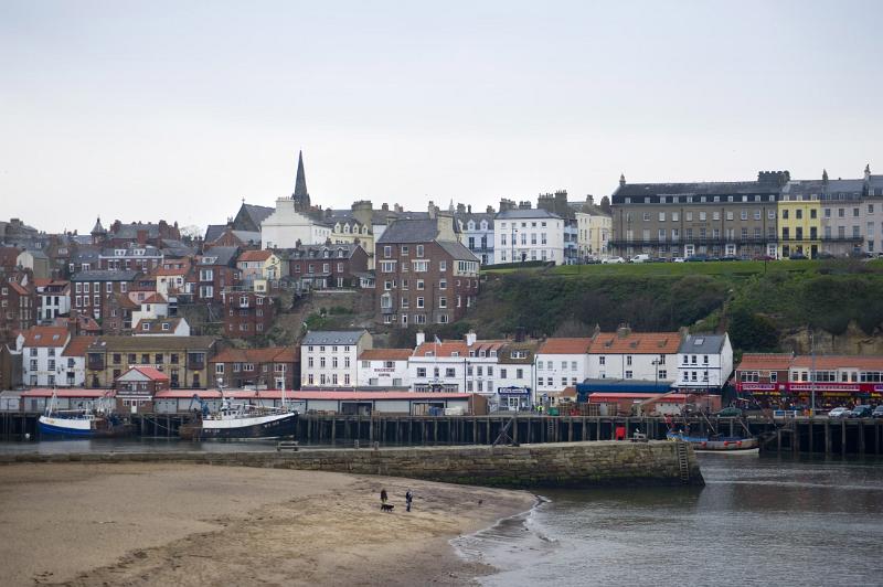 a view of tate hill sands and whitbys west cliff across the harbour