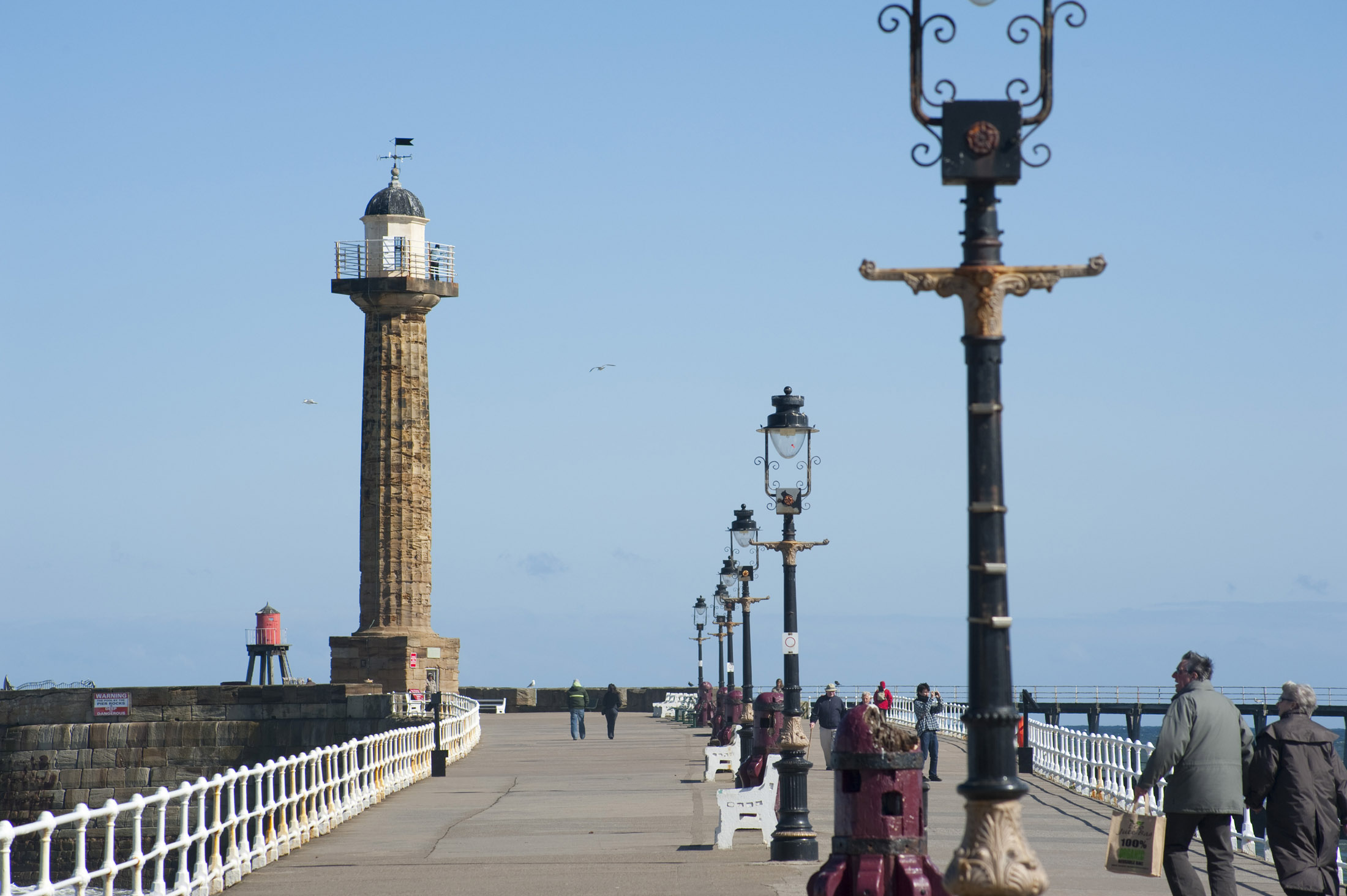 an image of view down the stone west pier to the Whitby West Breakwater Light