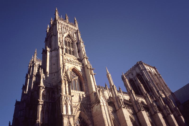 Exterior View of Historic York Minister Cathedral in York, England, Captured on Blue Gray Sky Background.