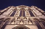 Looking up at the arched windows on the stone exterior facade of York Minster Cathedral, York, UK