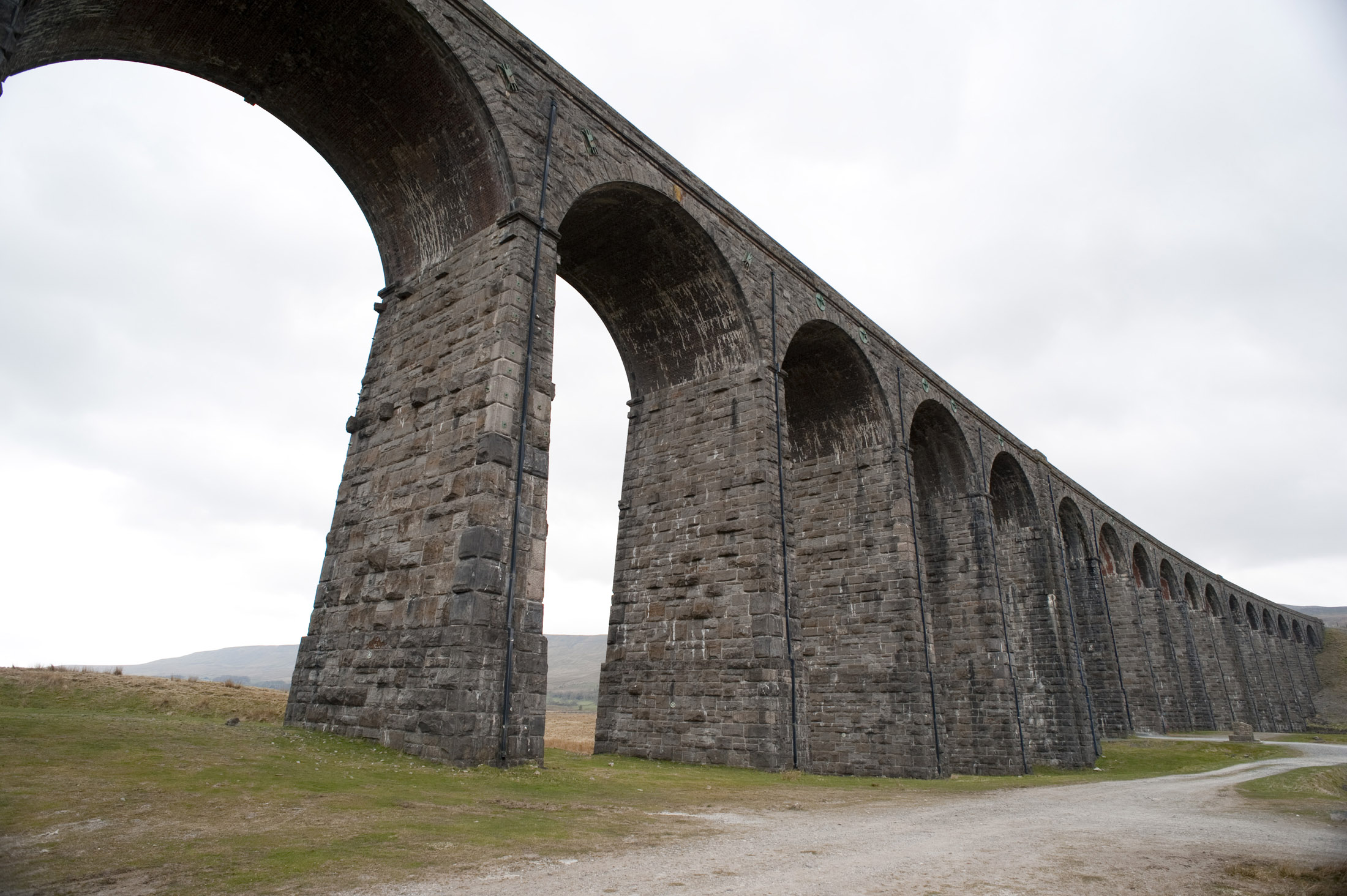 an image of wide angle image of the stone arches on the ribblehead viaduct