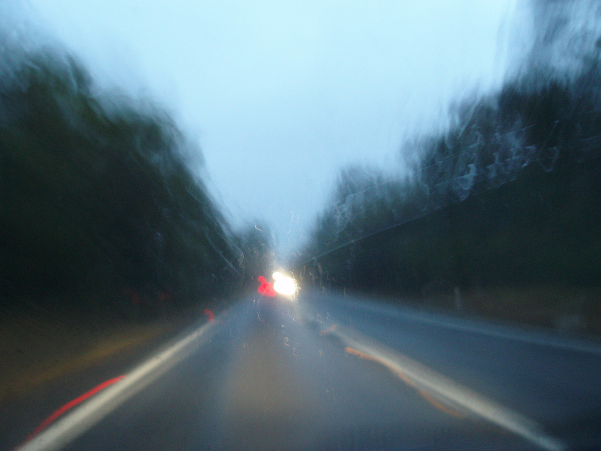 an image of Australia is a country of long road journeys - blurry In Motion Long Distance Road at Night Time While Driving.