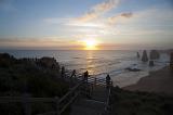 A beautiful hazy sunset over the ocean, coastline, viewing platform and the 12 Apostles on the Great Ocean Road in Australia.