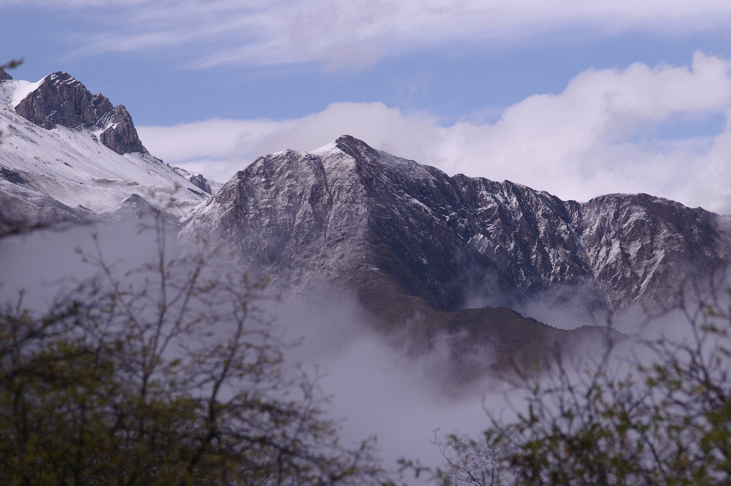 an image of Chinese Mountain Peak Partly covered with snow in the Winter Season.