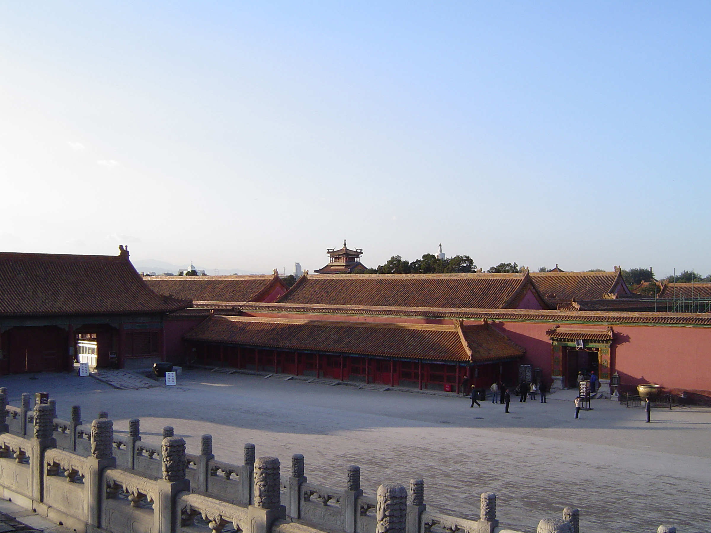 an image of Random Tourists at Famous Forbidden City Temple, the Imperial Palace, Located in China. Captured on Lighter Blue Sky Background.