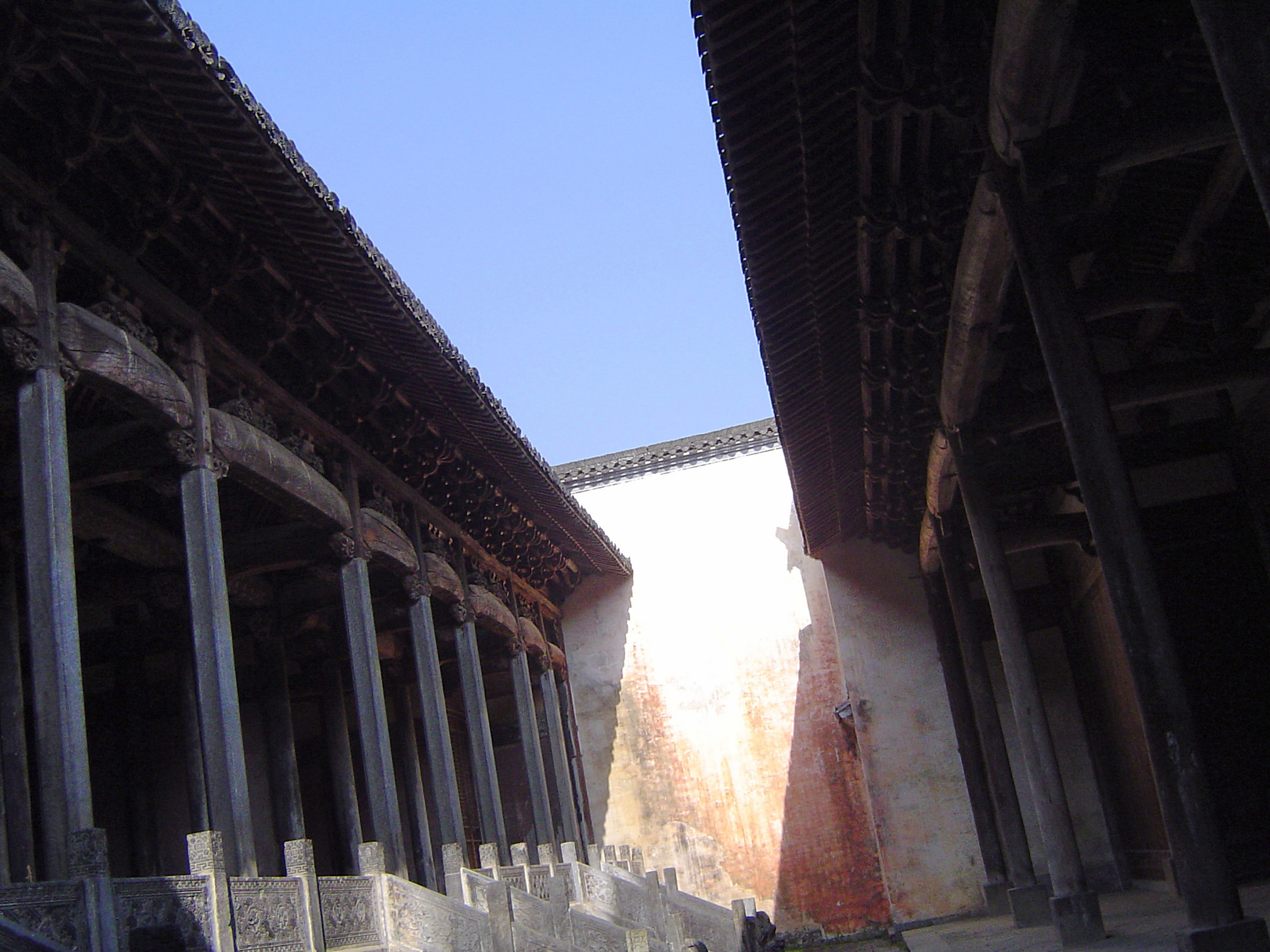 an image of Old Vintage Architectural Chinese Temple Structure Detailed Design on Lighter Blue Sky Background.