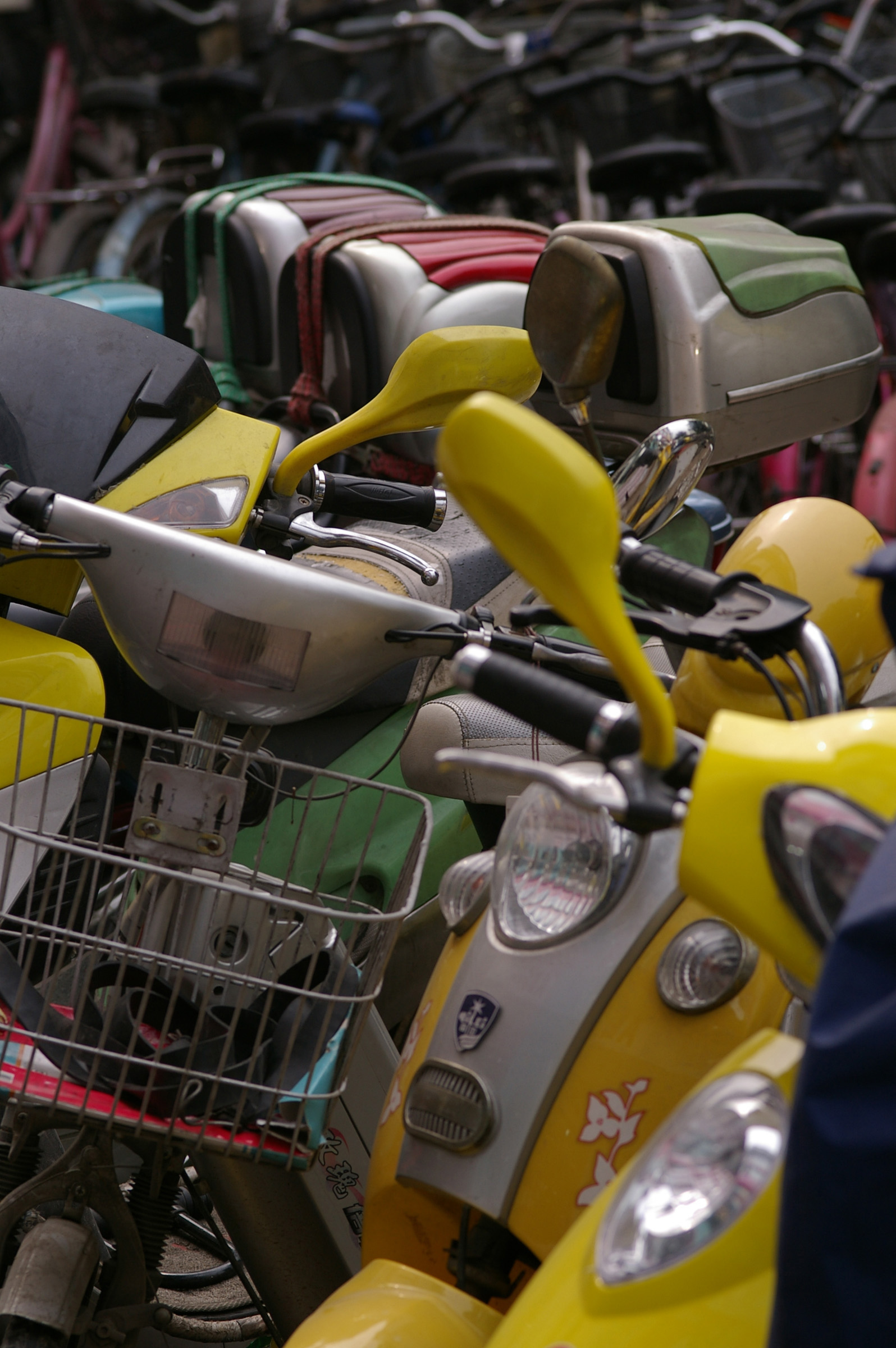 an image of Close up Various Colored Motorbikes Parked at the Street in China.