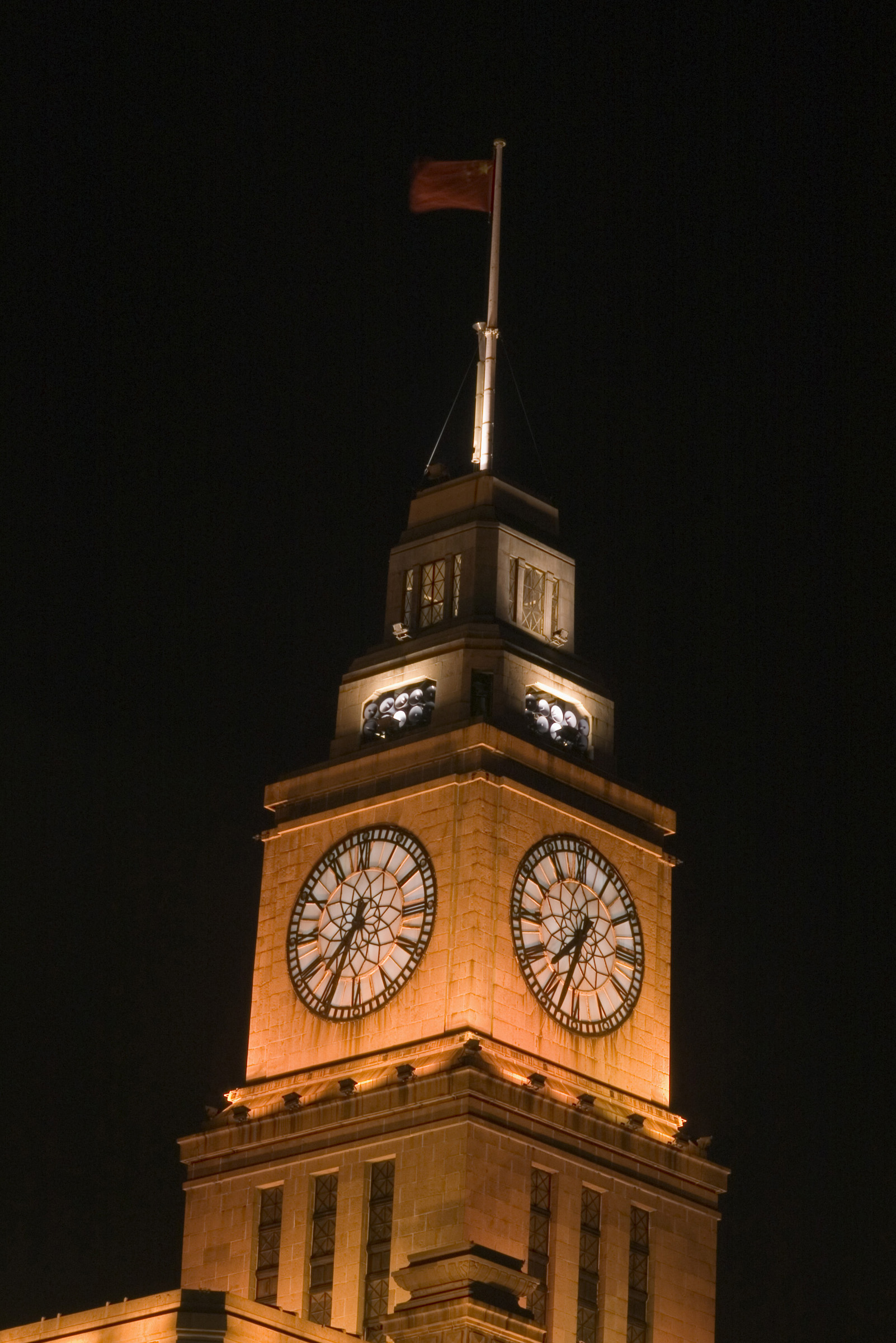 an image of Famous Big Clock on Eight Storey Custom House Wall at the Bund, Shanghai China. Captured at Night Time.